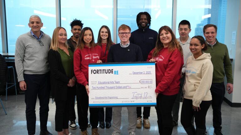 Fortitude Re employees and Ed Arts leaders with a $200,000 check